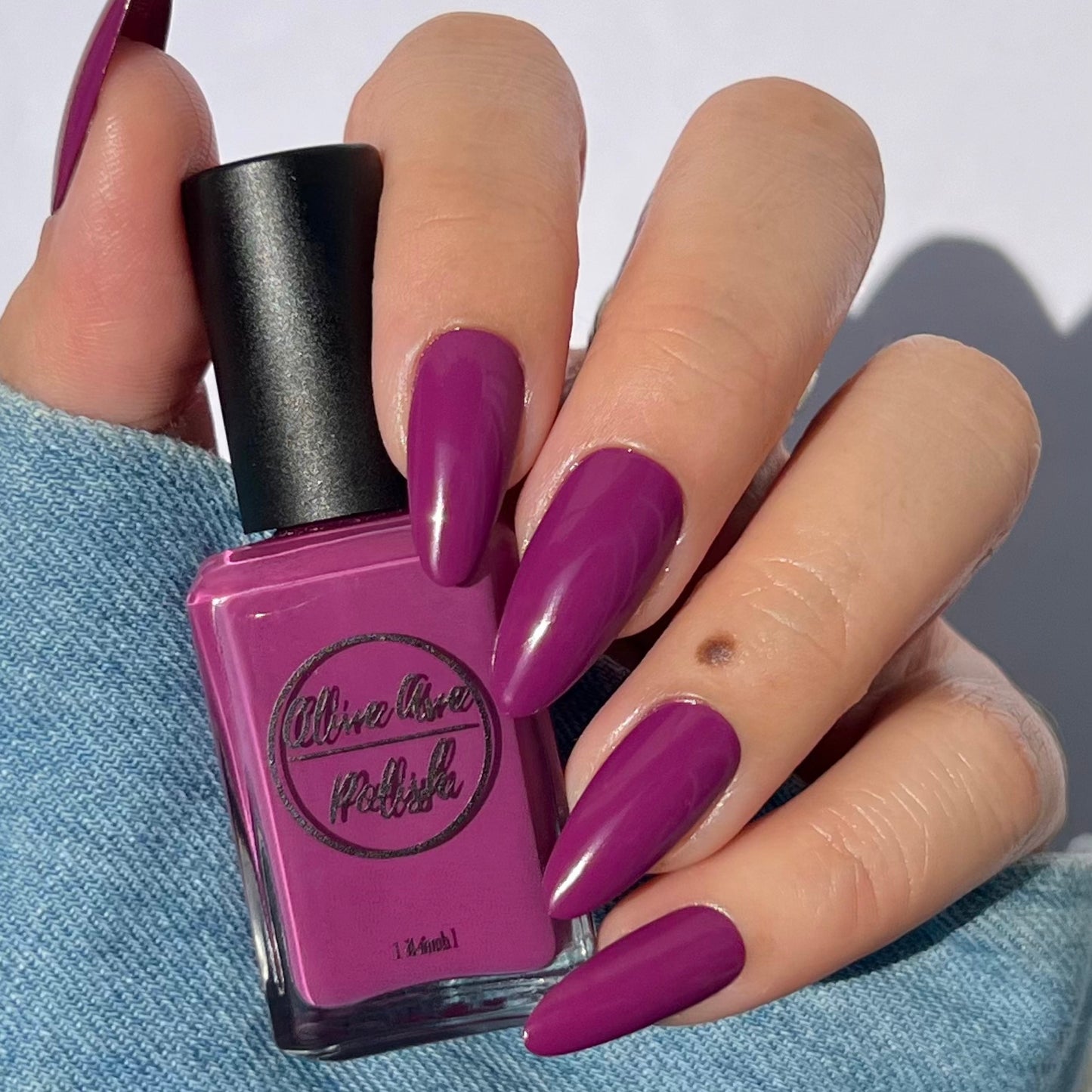magenta nail polish swatch on pale skin tone