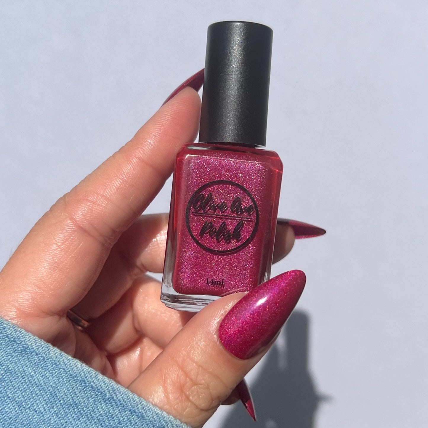 pink holographic nail polish swatch on pale skin tone
