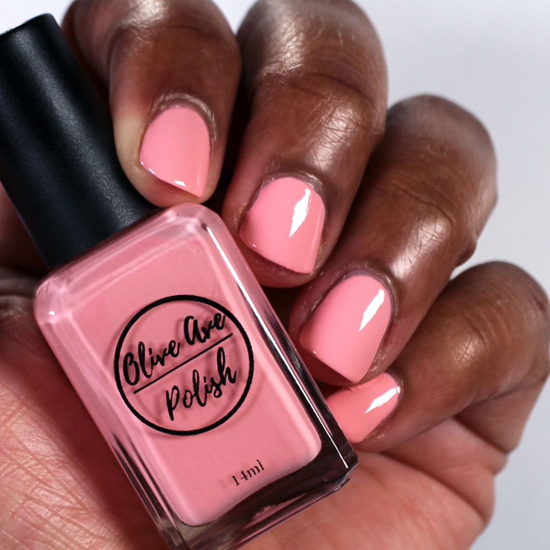 pastel coral nail polish on dark skin tone