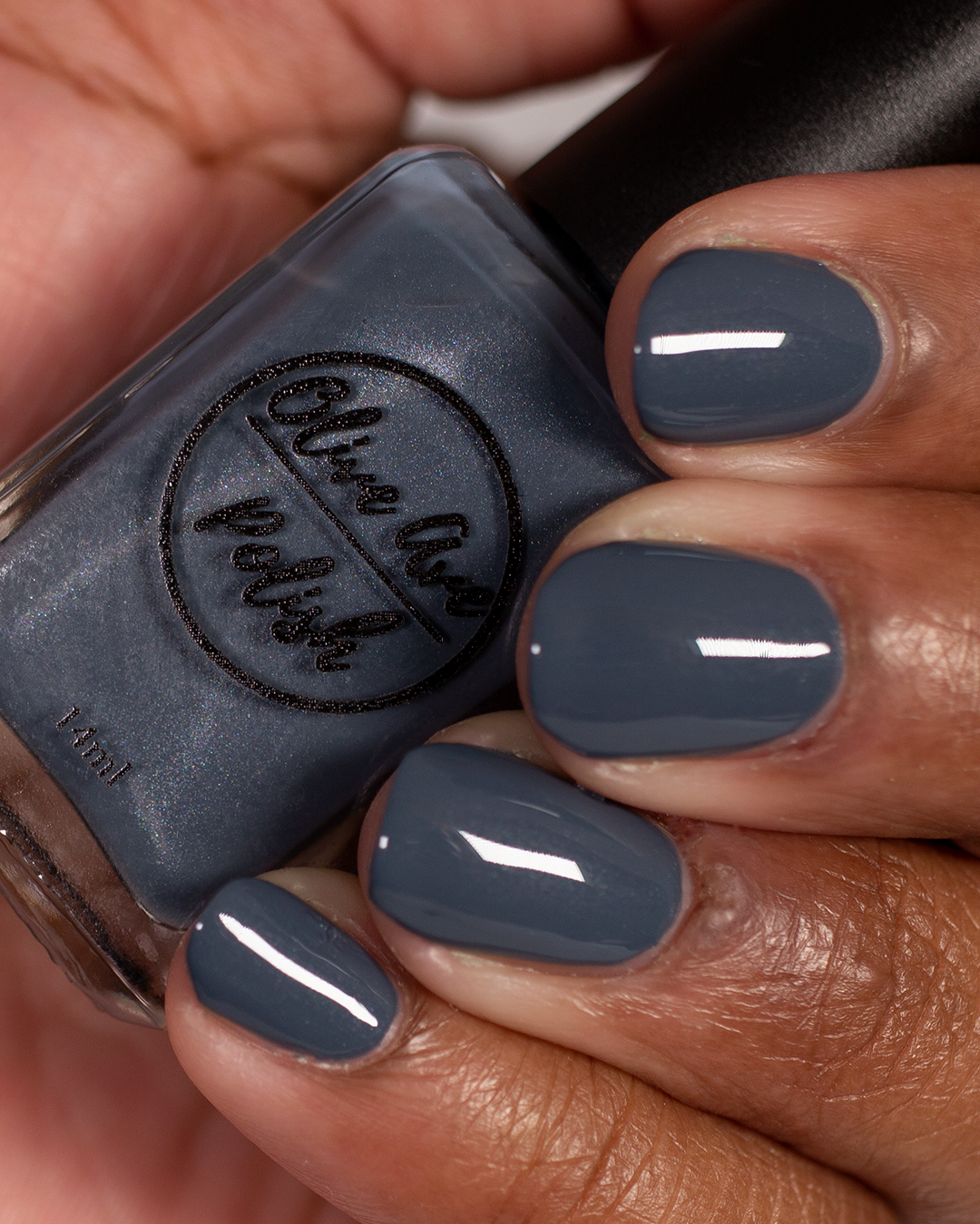 blue grey nail polish swatch on medium skin tone