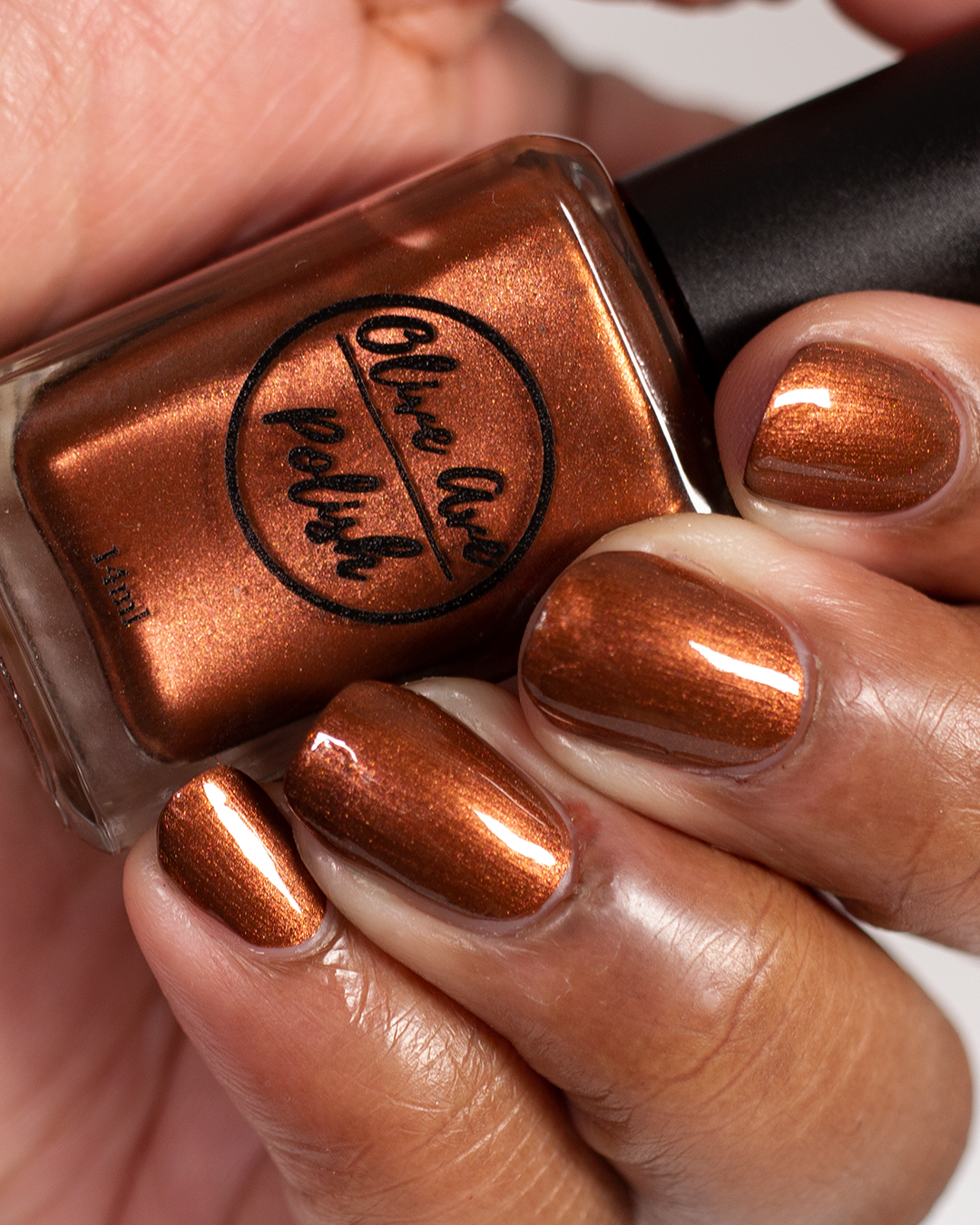metallic brown nail polish swatch on medium skin tone