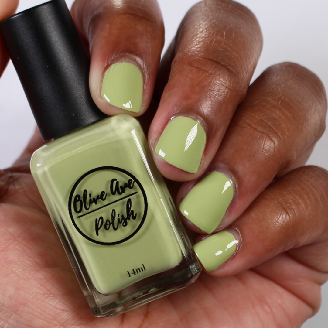 pastel green nail polish swatch on medium deep skin tone