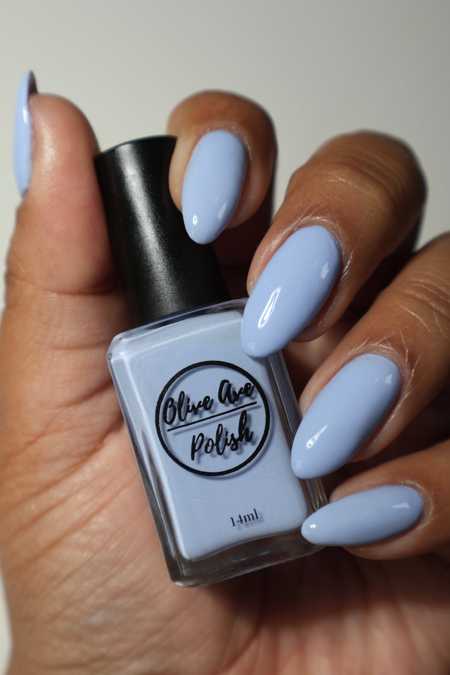 light periwinkle nail polish swatch on medium skin tone