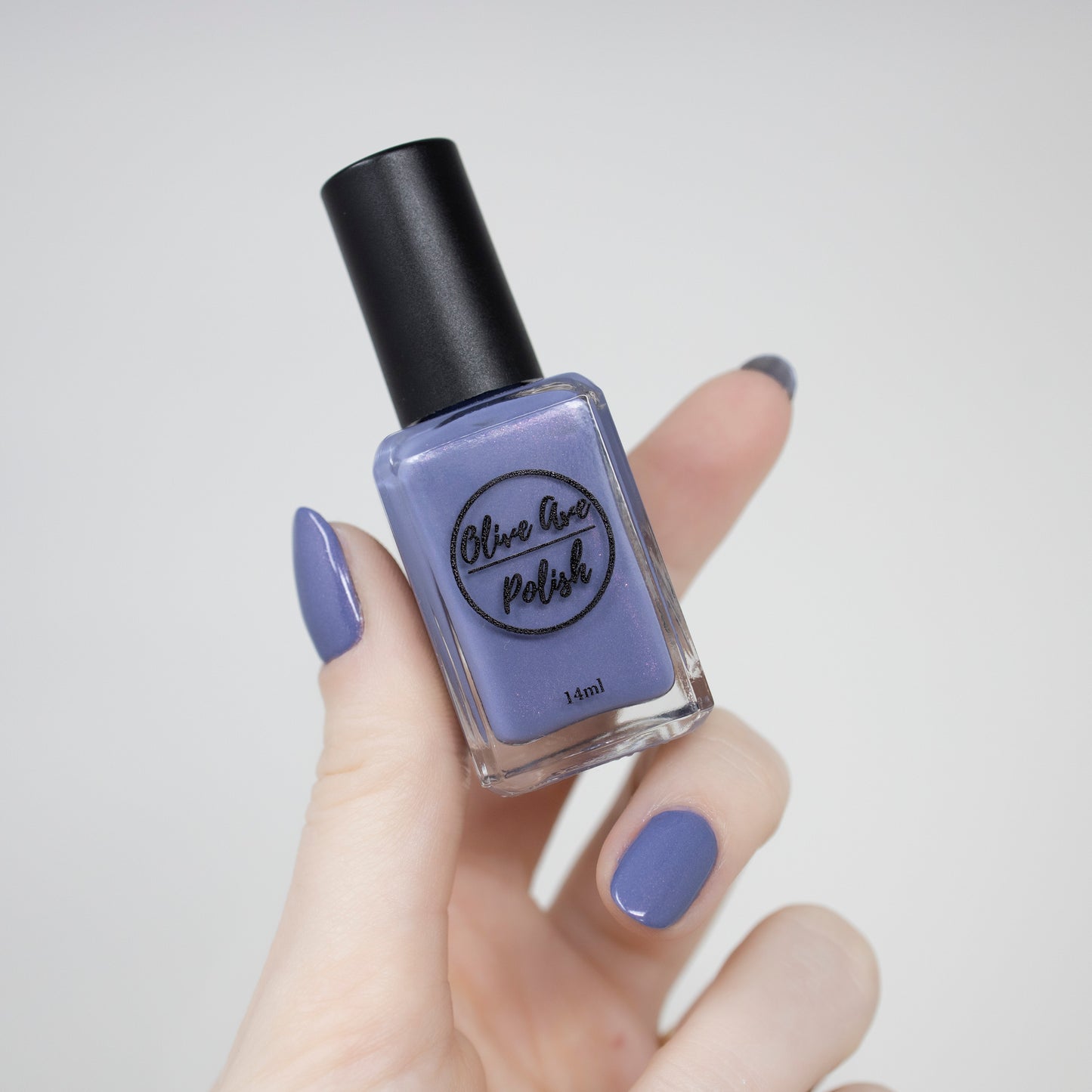 Purple shimmer nail polish swatch on pale skin tone