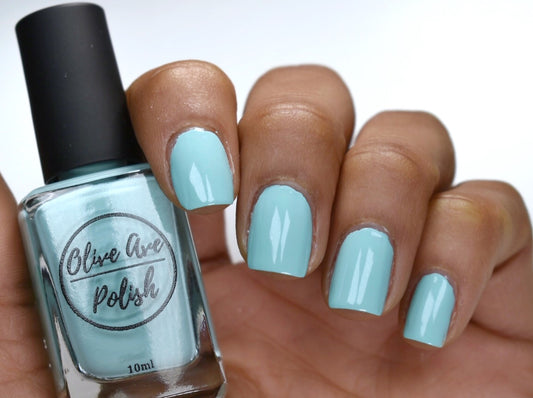 Tiffany blue nail polish swatch on medium skin tone