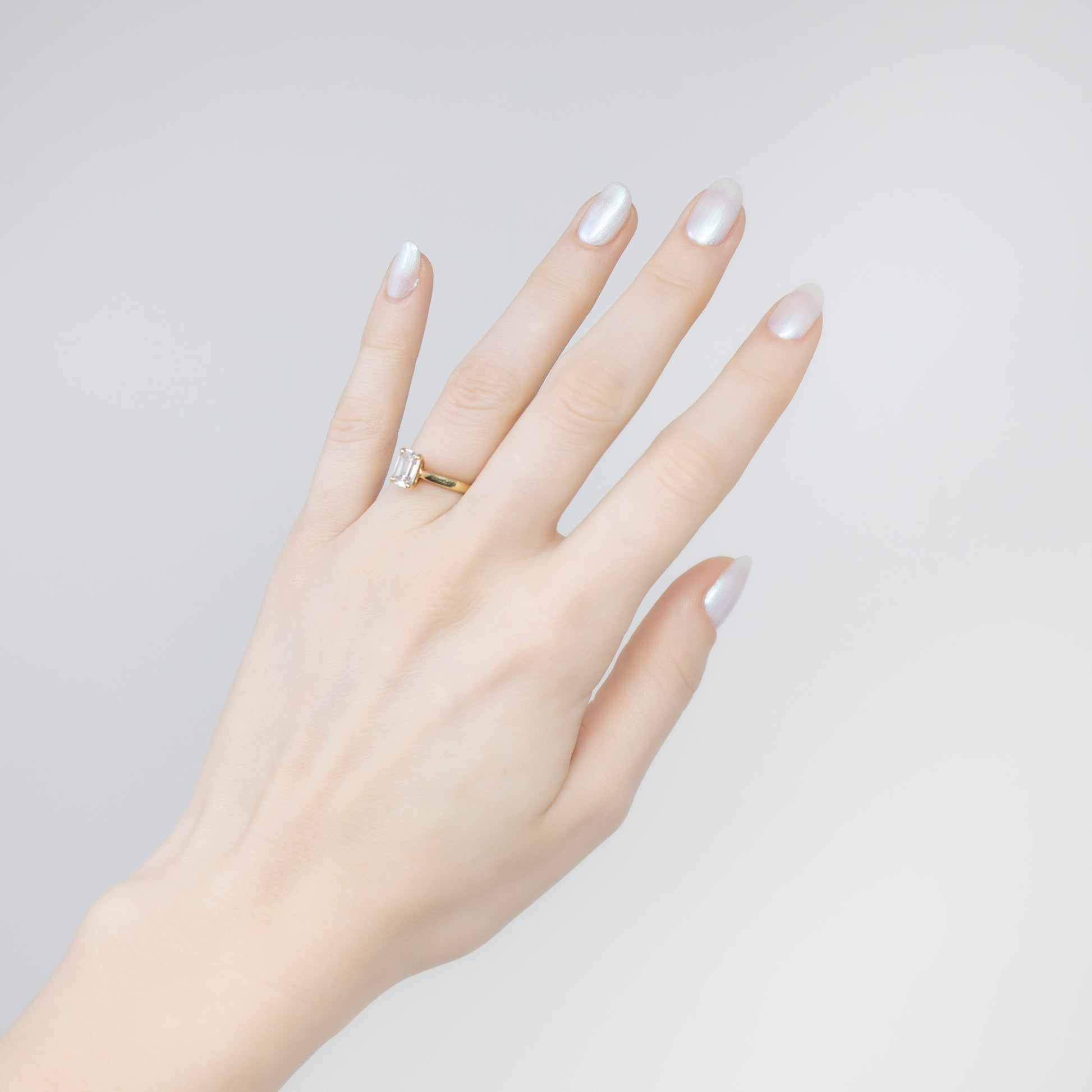 White pearl nail polish swatch on pale skin tone