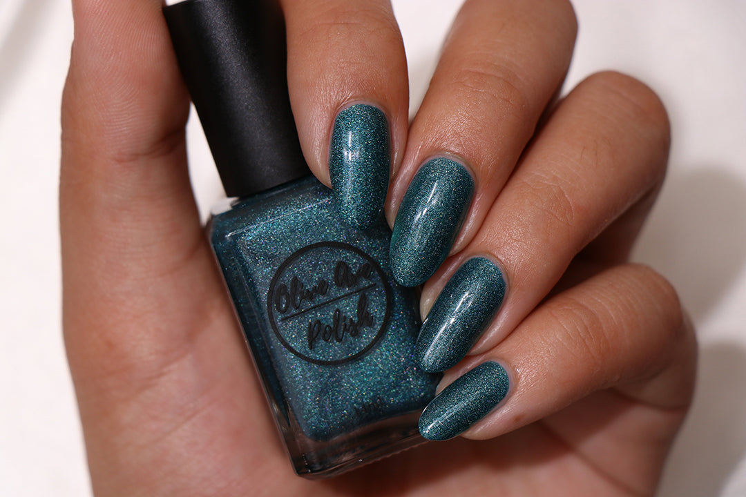 Teal Blue holographic nail polish swatch on medium skin tone