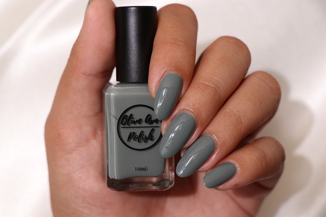 sage green nail polish swatch on pale skin tone