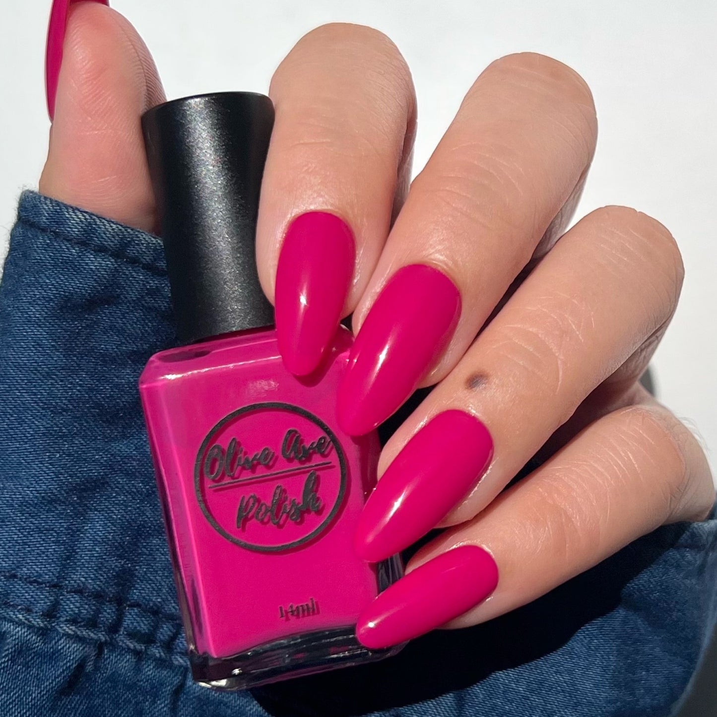 bright pink nail polish swatch on pale skin tone