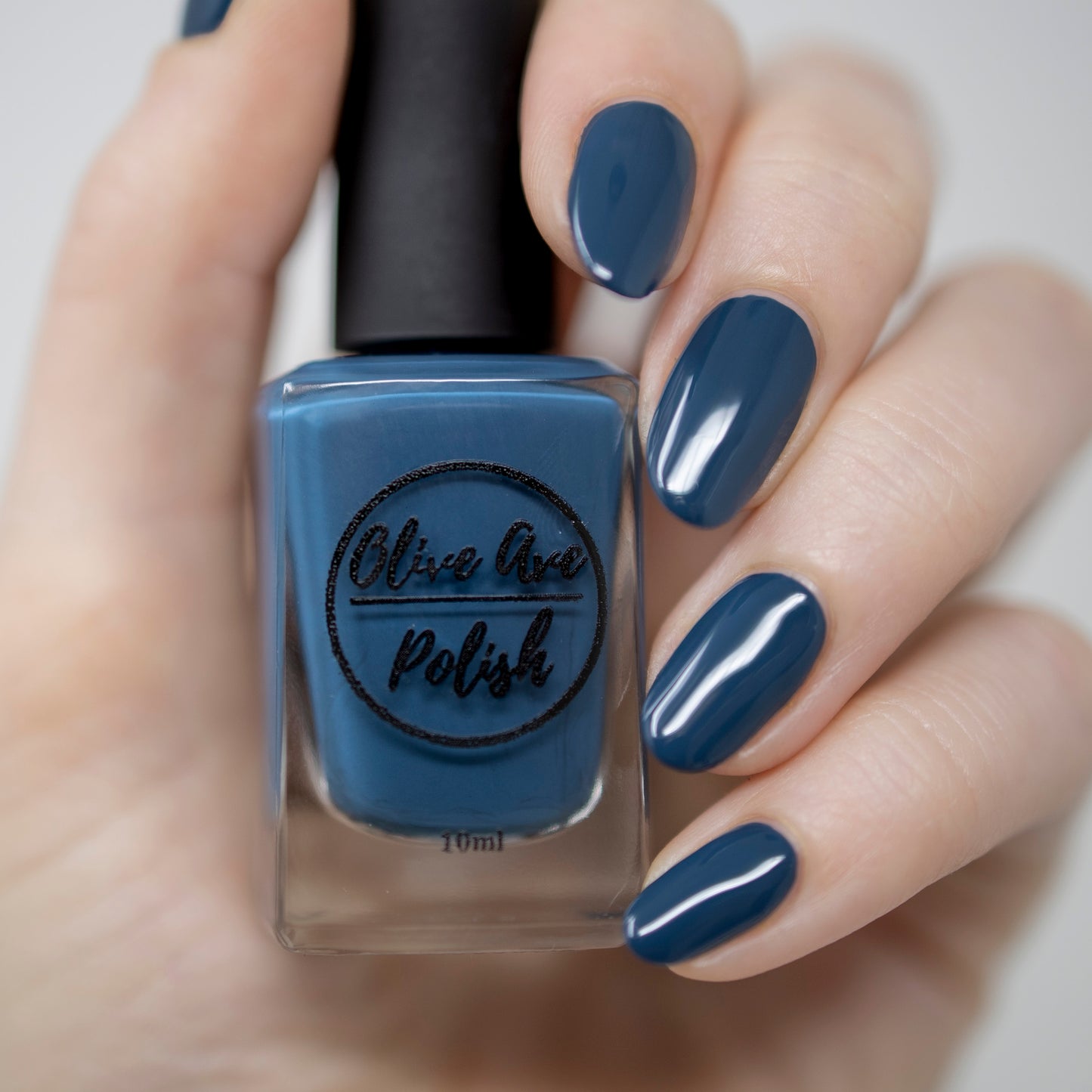 Peacock blue nail polish swatch on pale skin tone