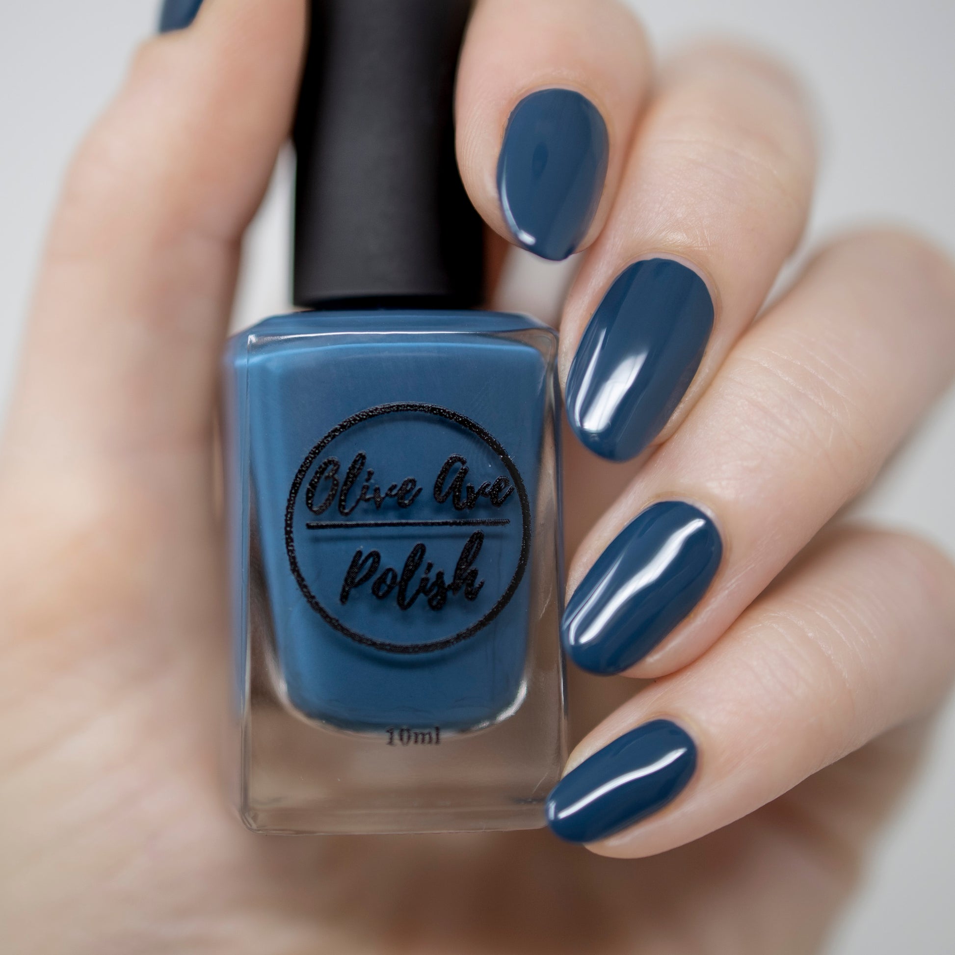Peacock blue nail polish swatch on pale skin tone