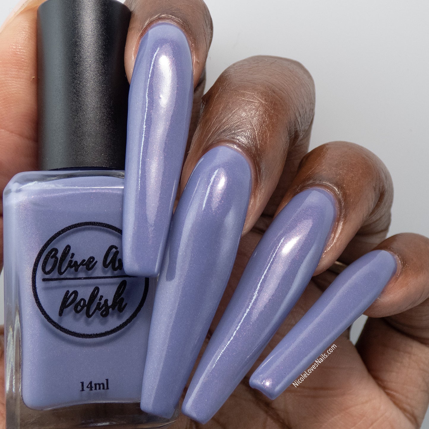 Purple shimmer nail polish swatch on deep skin tone