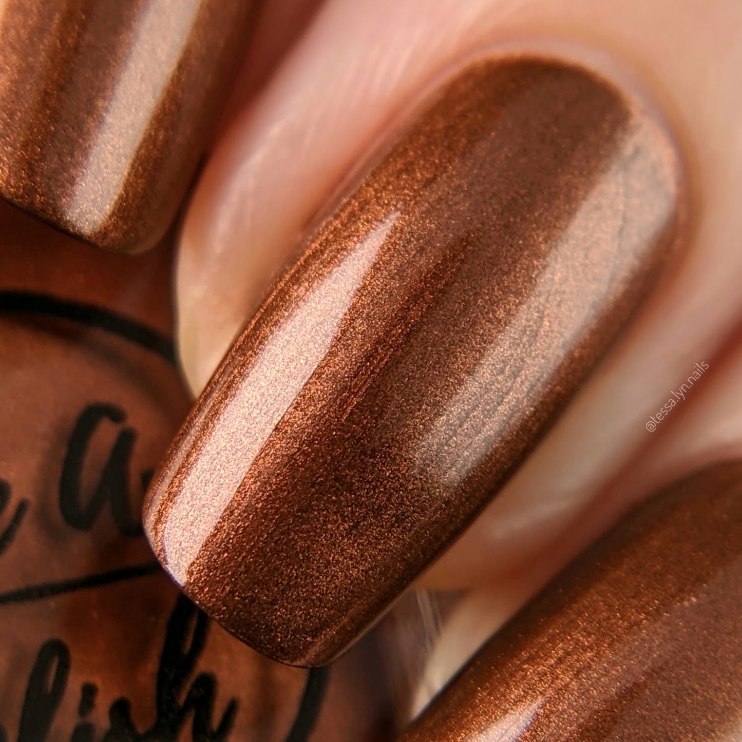 metallic brown nail polish swatch on pale skin tone