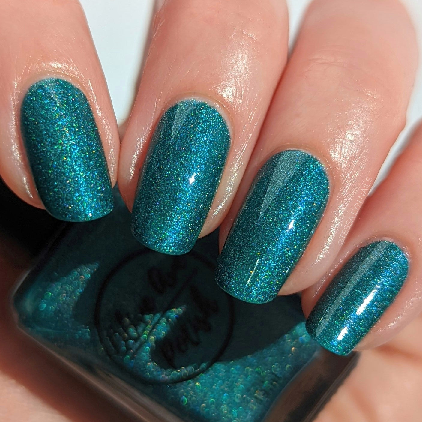 Teal Blue holographic nail polish swatch on pale skin tone