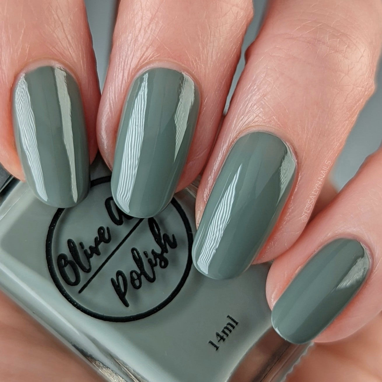 sage green nail polish swatch on pale skin tone