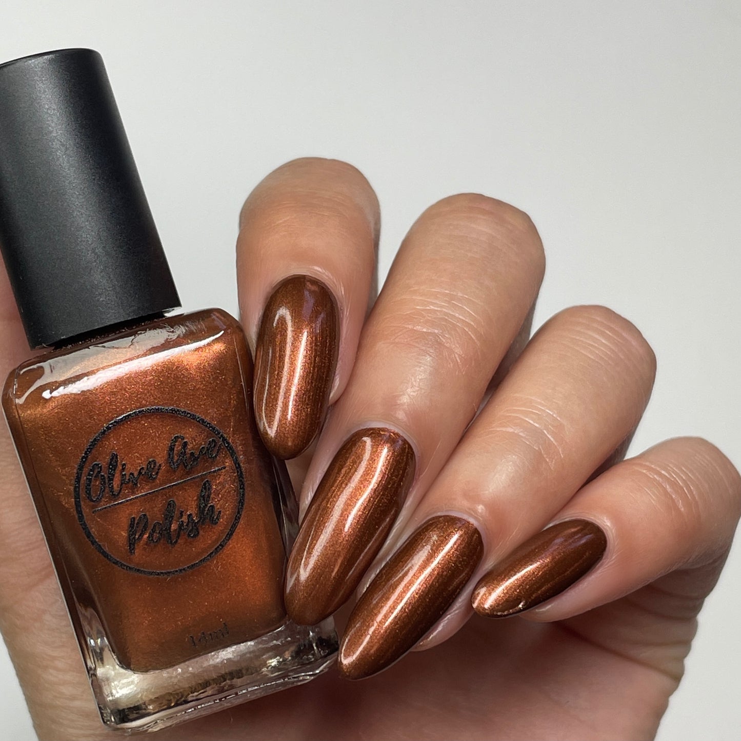 metallic brown nail polish swatch on pale skin tone