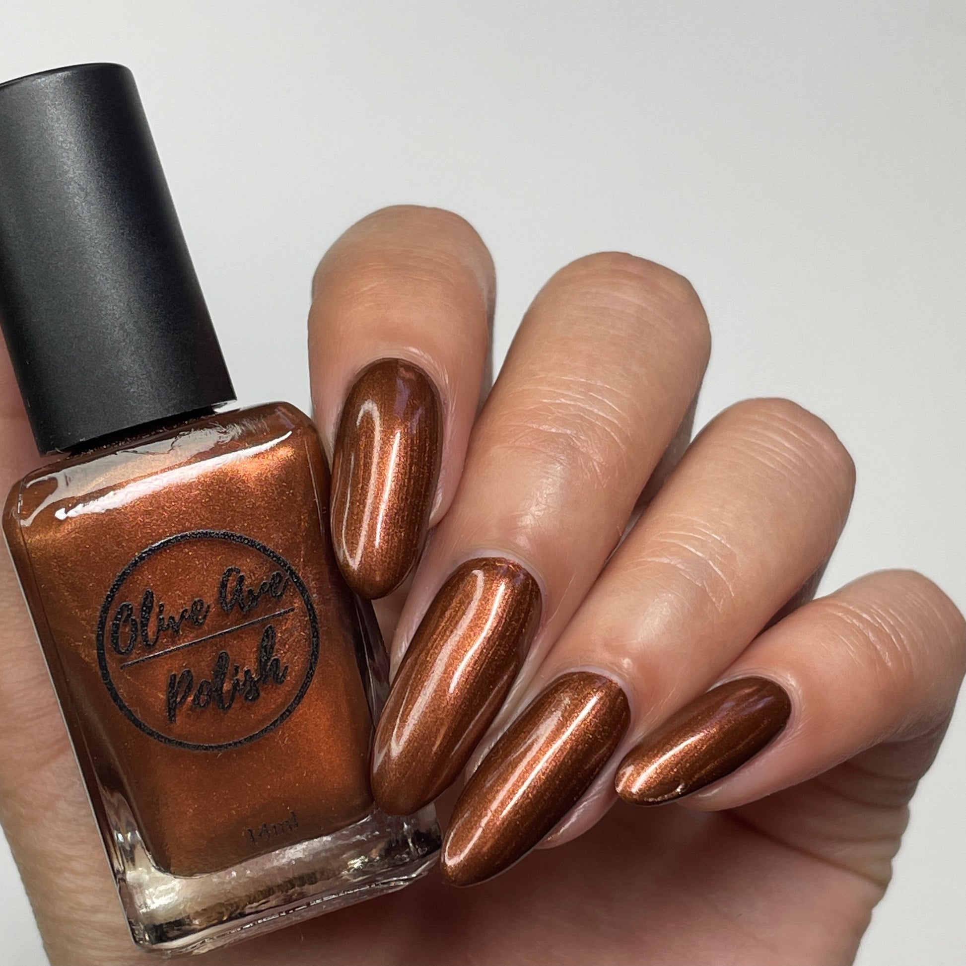metallic brown nail polish swatch on pale skin tone