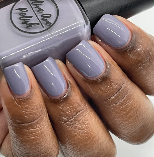 purple grey nail polish swatch on medium dark skin tone