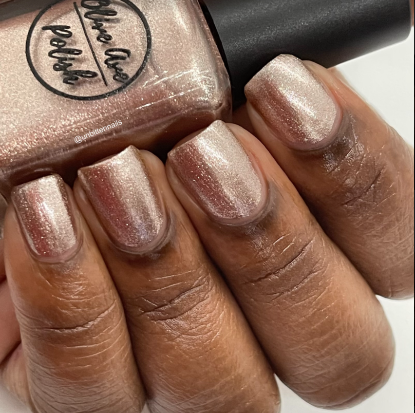 rose gold nail polish swatch on medium deep skin tone
