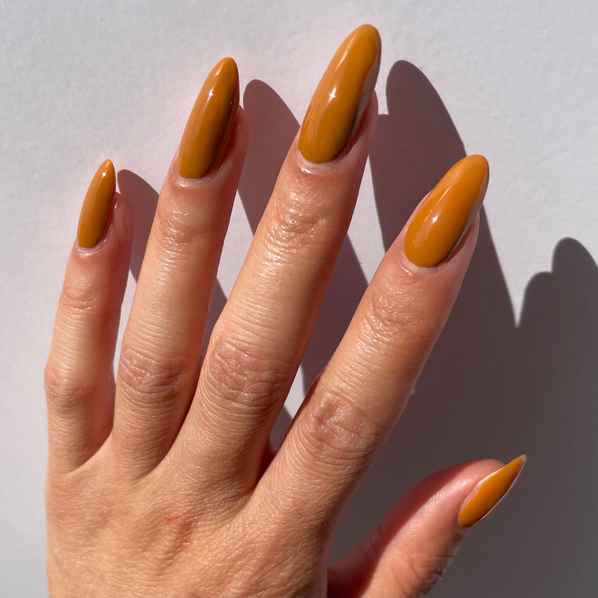 caramel nail polish swatch on pale skin tone