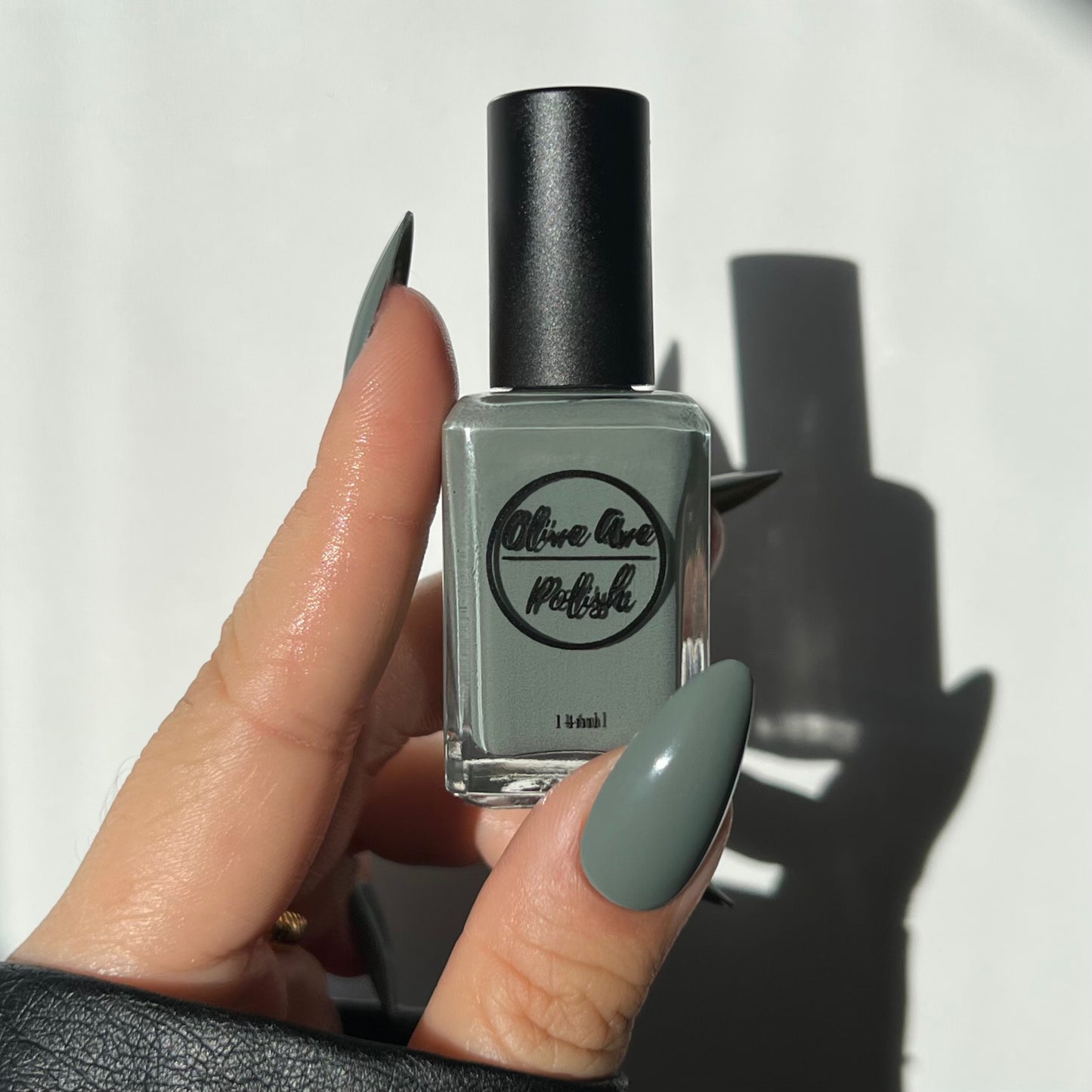 sage green nail polish swatch on pale skin tone