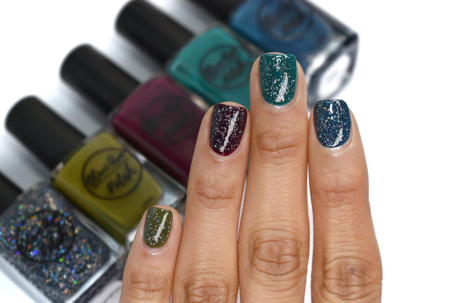 Black holographic nail polish swatch on pale skin tone