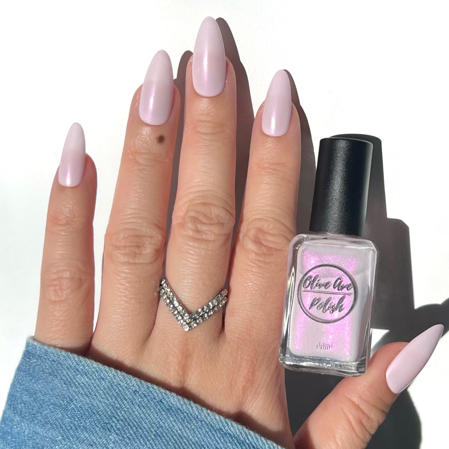 Light purple shimmer nail polish swatch on pale skin tone