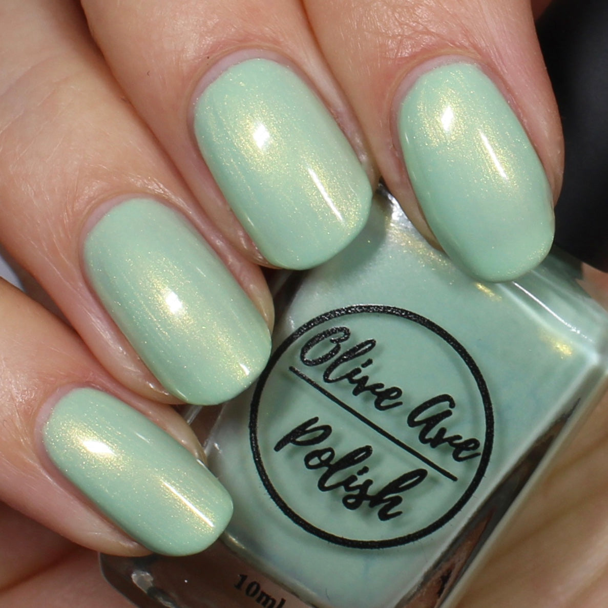 Spring green nail polish on pale skin tone