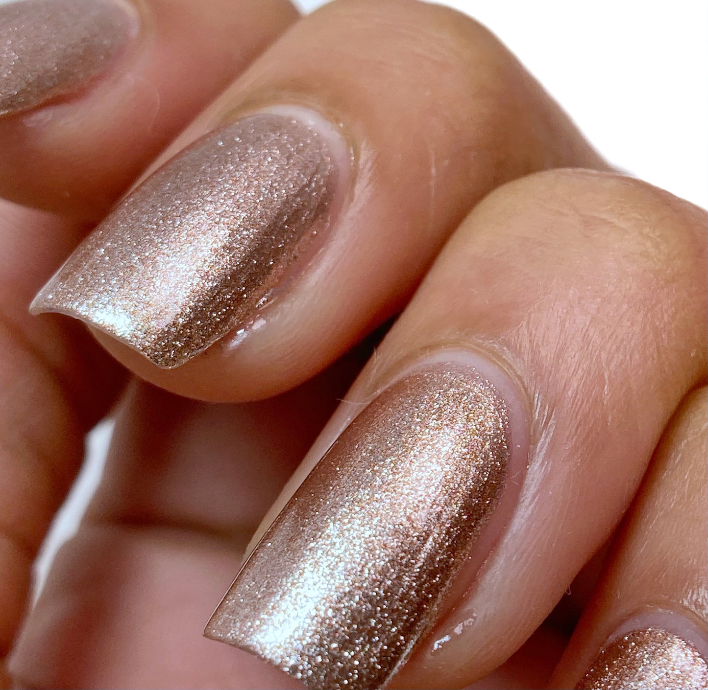 rose gold nail polish swatch on pale skin tone