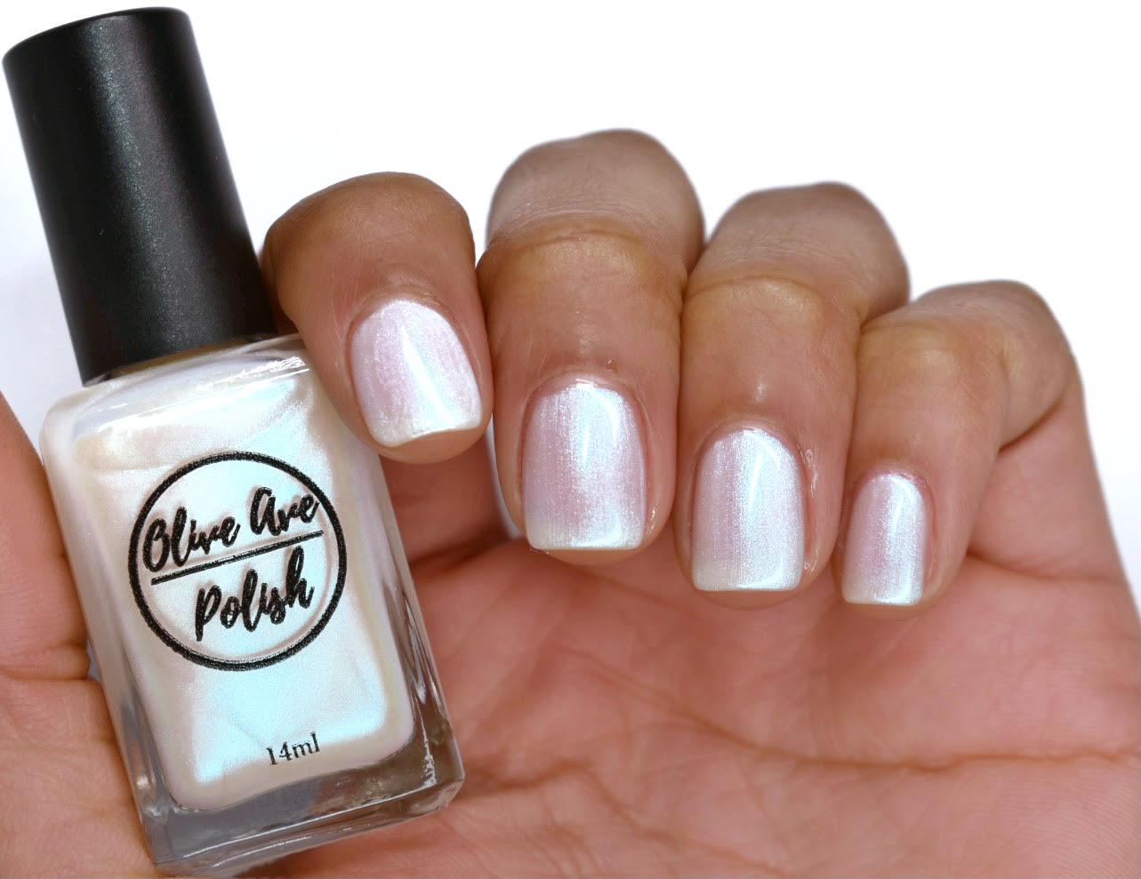 White pearl nail polish swatch on medium skin tone