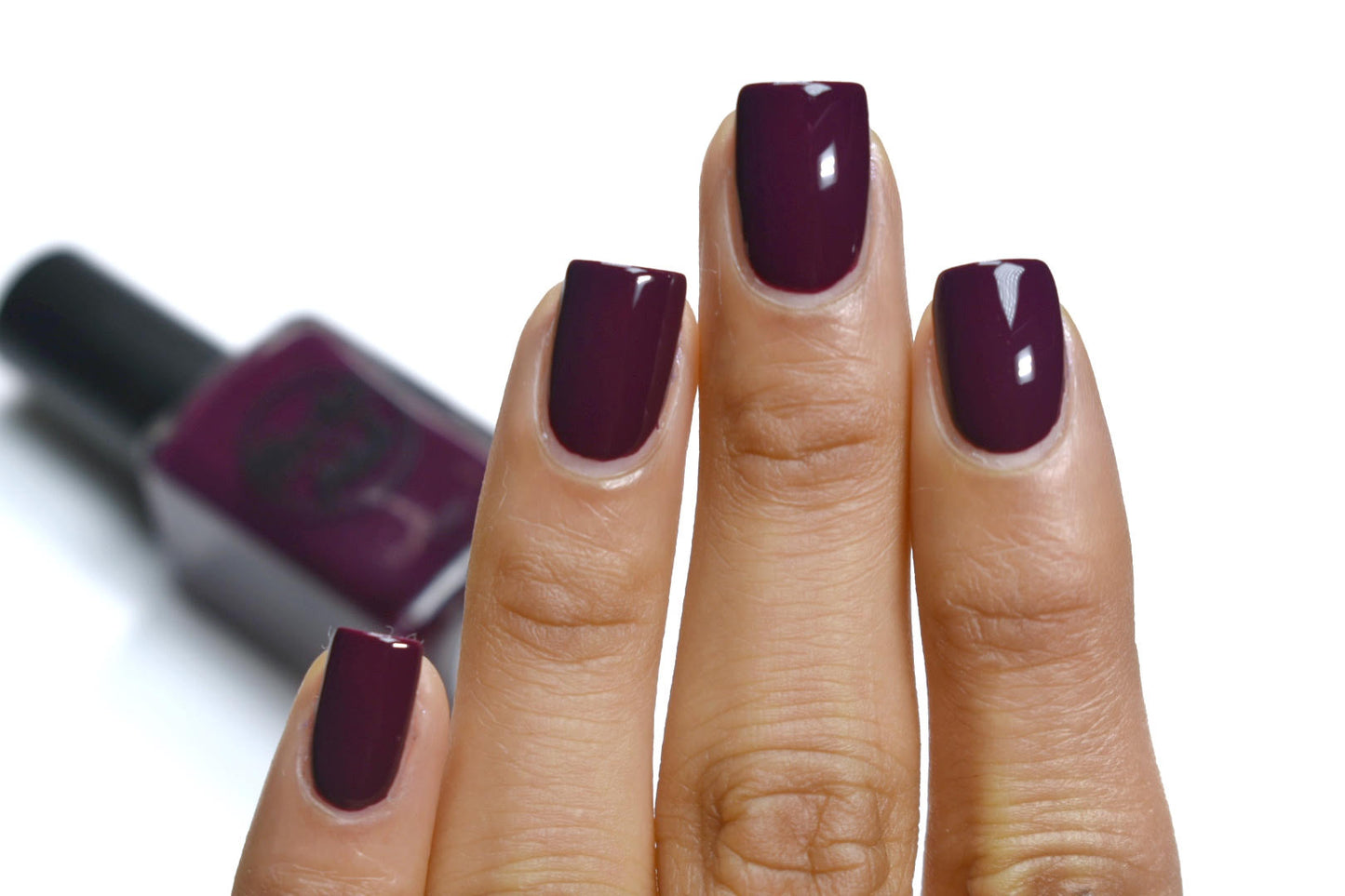 wine red nail polish swatch on medium skin tone