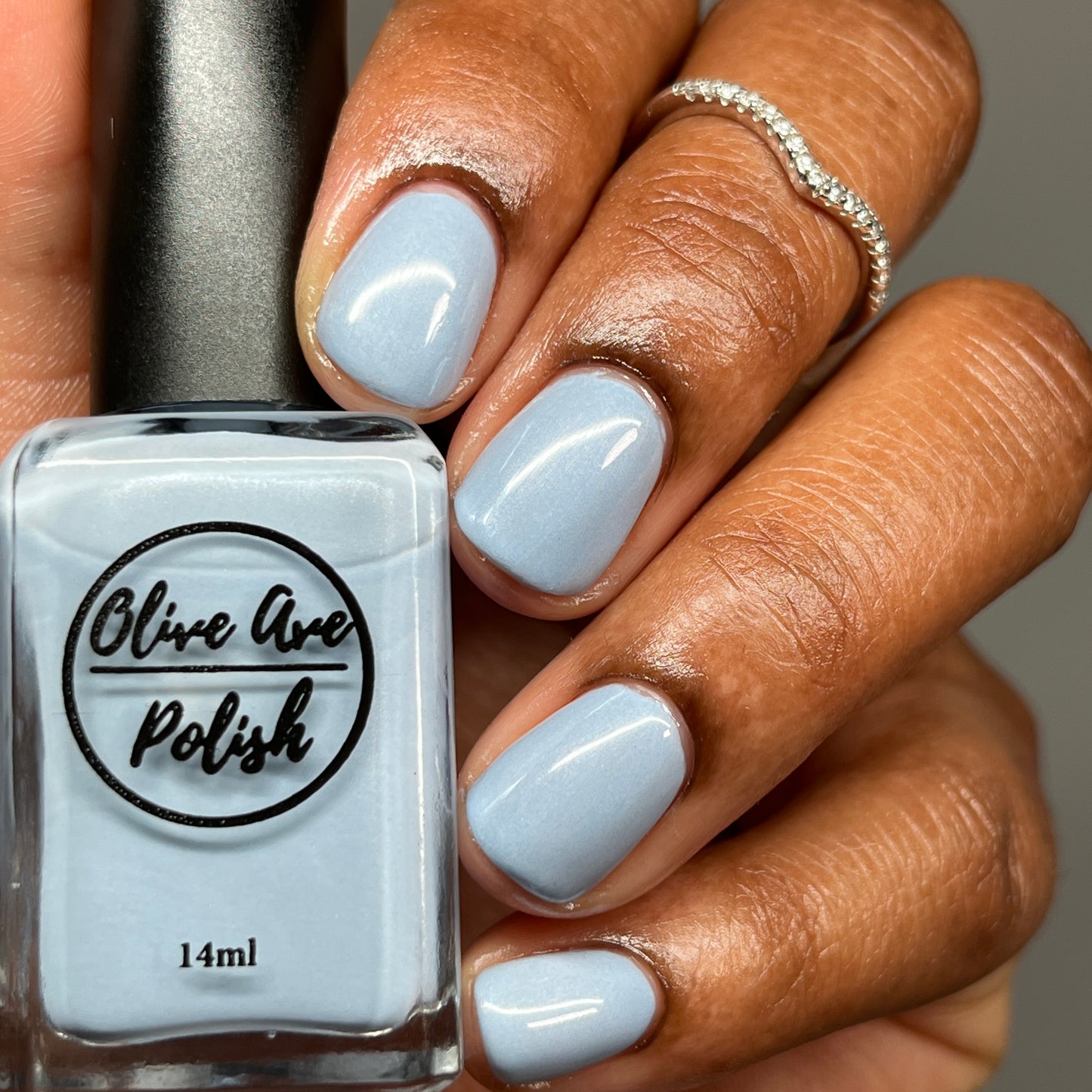 Pastel blue pearl nail polish on dark skin