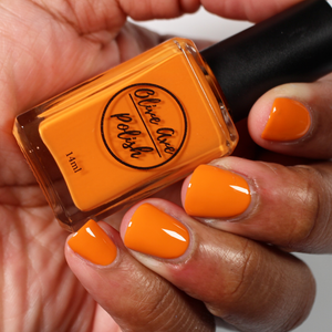 Fall orange nail polish swatch on medium dark skin tone