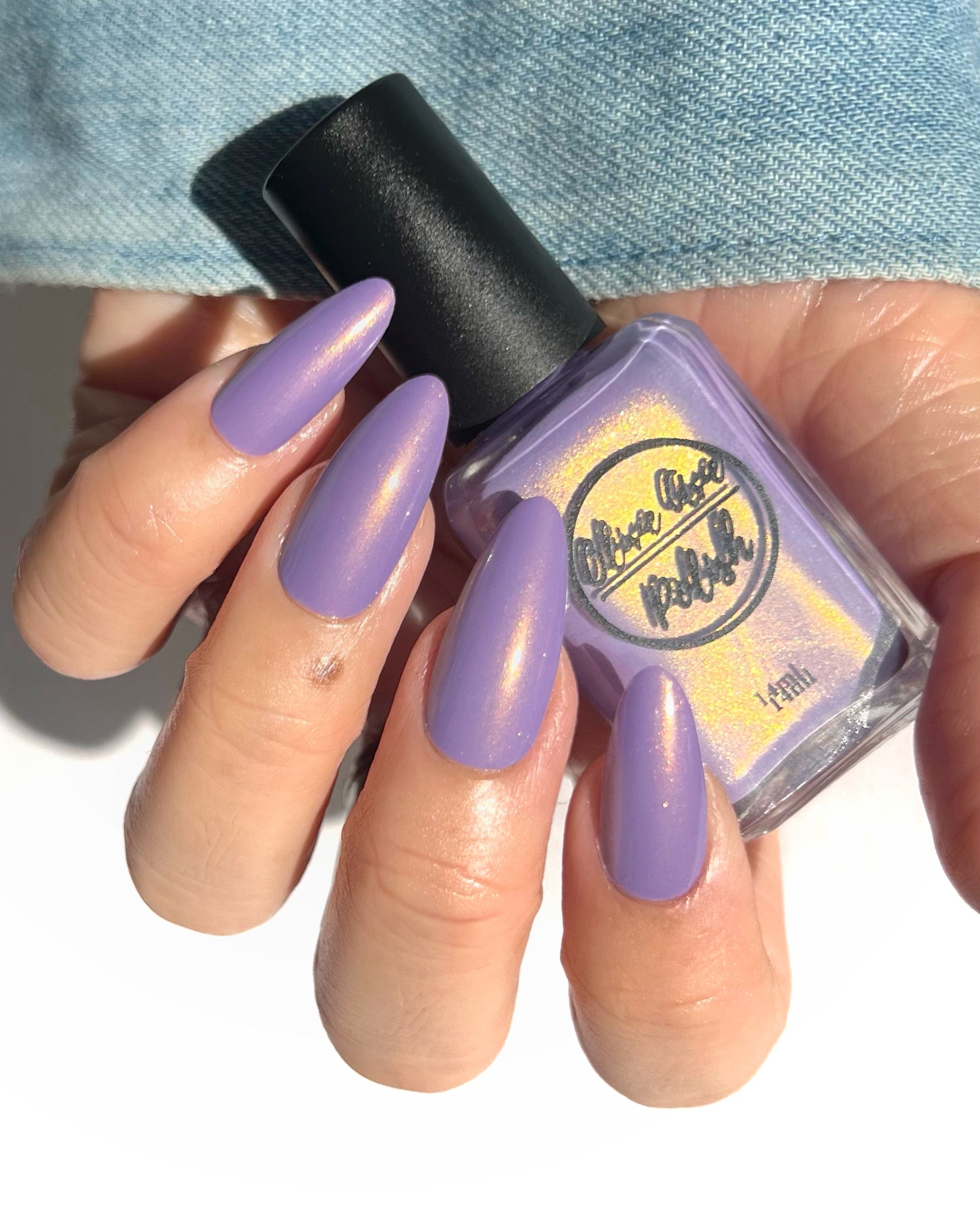 Warm purple with golden glow cream nail polish on light skin