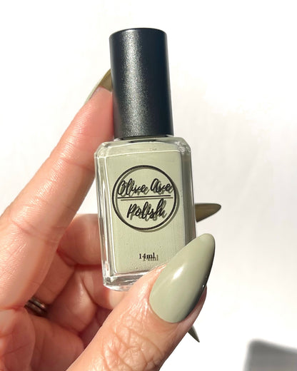 Light sage cream nail polish on light skin