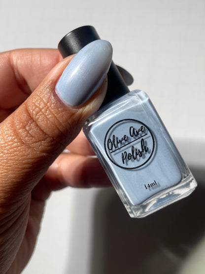 Pastel blue pearl nail polish on medium dark skin 