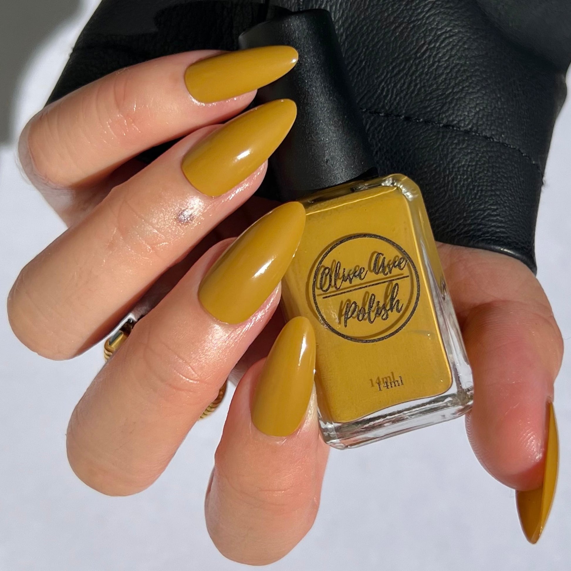 mustard yellow nail polish on medium asian tone