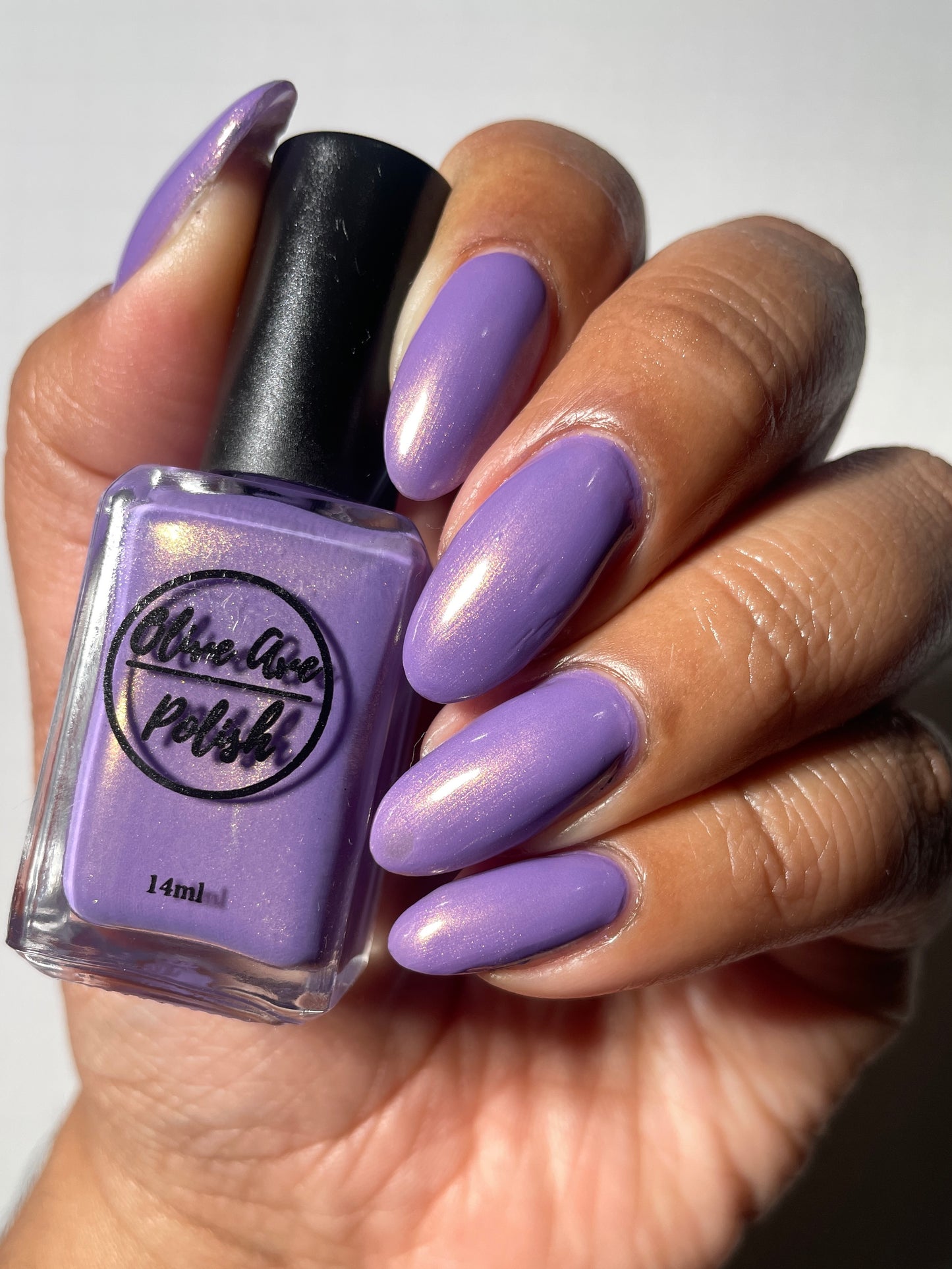 Warm purple with golden glow cream nail polish on medium dark skin