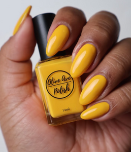 sunny yellow nail polish swatch on deep skin tone