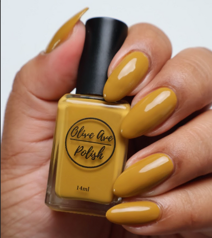 mustard yellow nail polish on medium skin tone