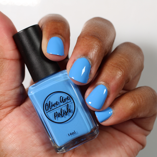 Bright Sky Blue nail polish swatch on medium skin tone
