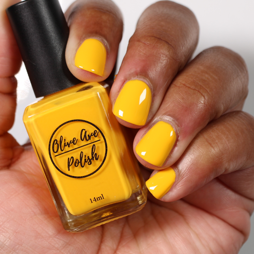 sunny yellow nail polish swatch on medium skin tone