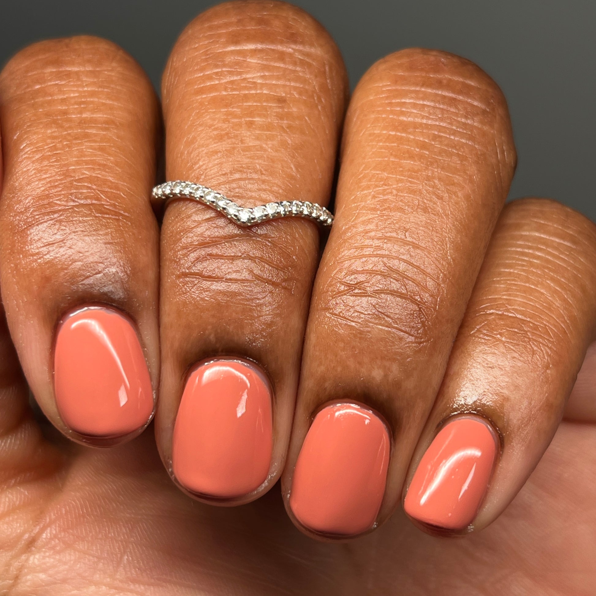 Light terracotta cream nail polish on dark skin