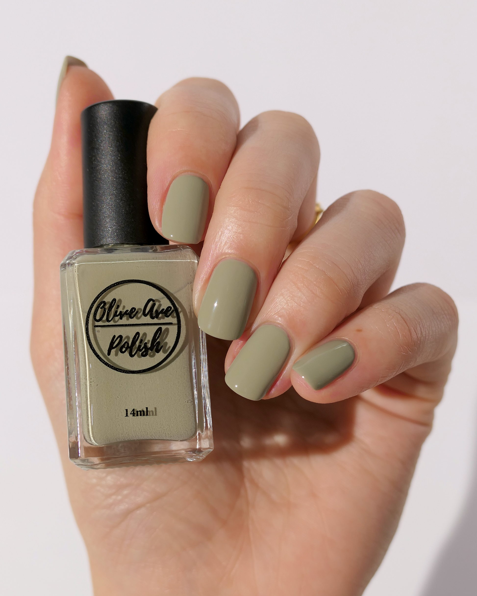 Light sage cream nail polish on light skin