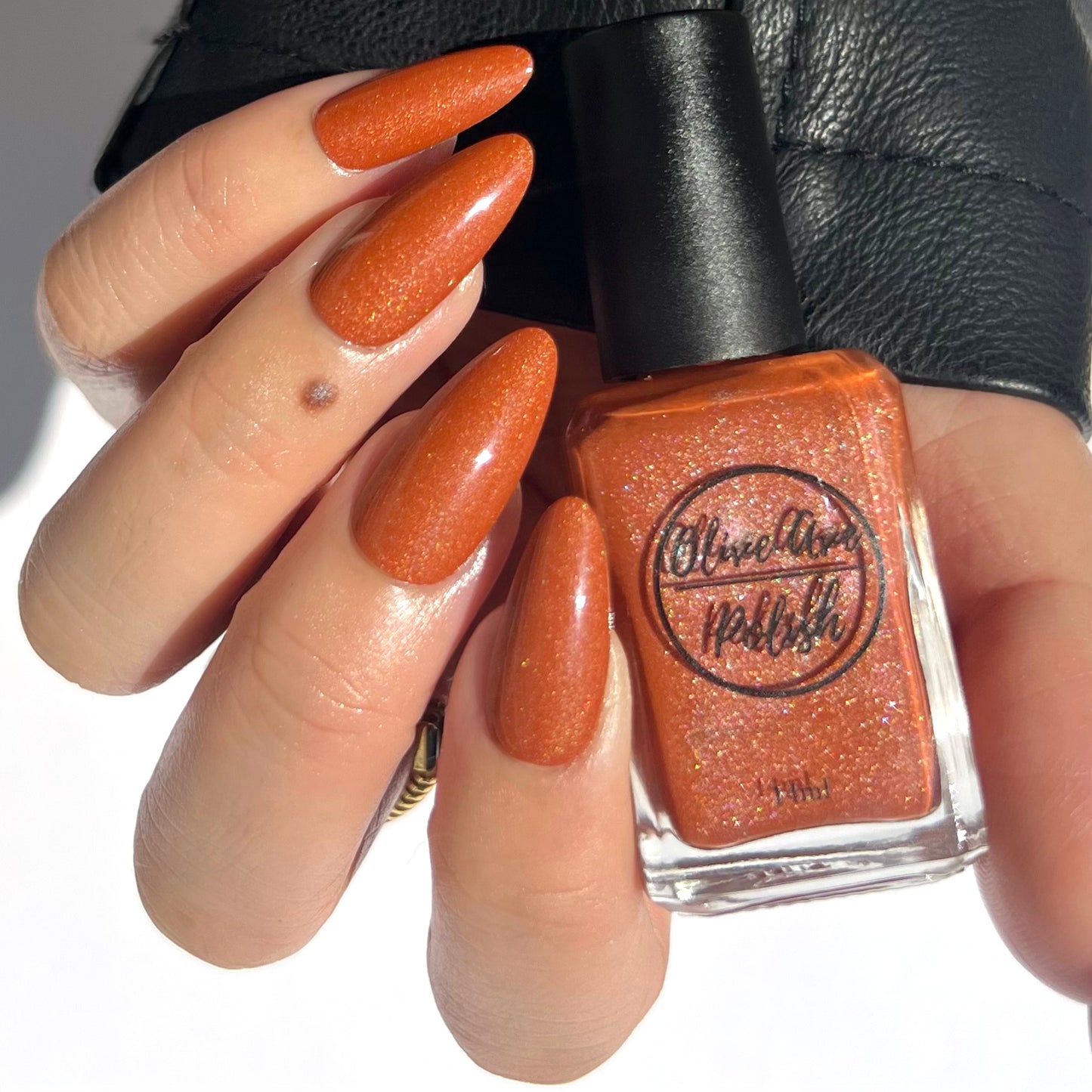 orange holographic nail polish on asian skin tone