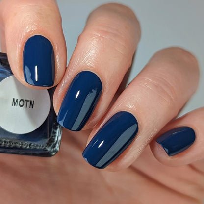 navy blue nail polish on pale skin tone