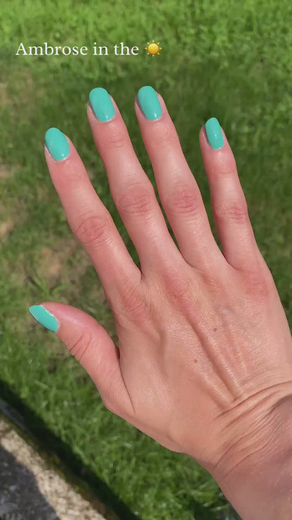 Blue green nail polish in sun and indoors