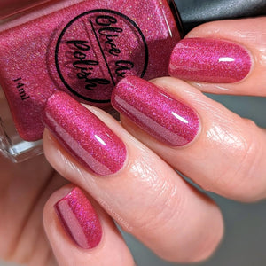 pink holographic nail polish swatch on pale skin tone