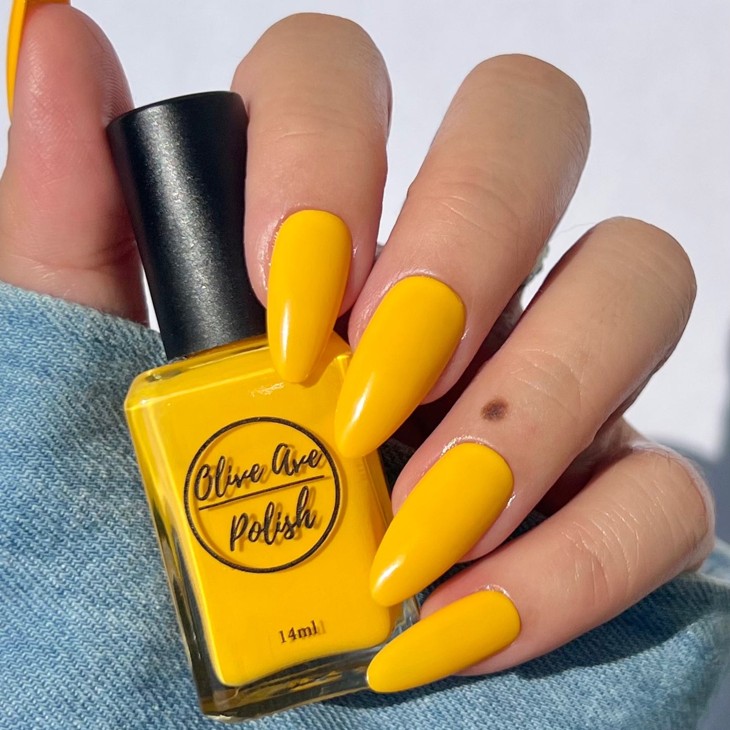 sunny yellow nail polish swatch on pale skin tone
