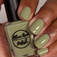 sage green nail polish swatch on medium skin tone